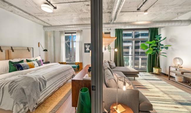 a bedroom with a couch and a bed