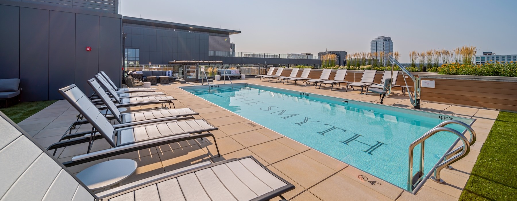 a swimming pool with chairs around it