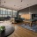 a clubhouse room with tables, chairs and a tv