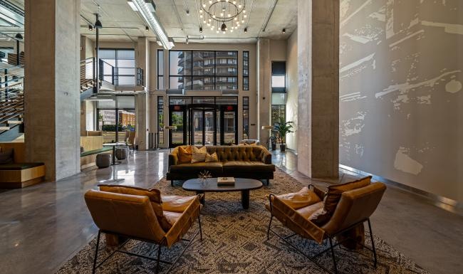 a clubhouse room with a couch and chairs