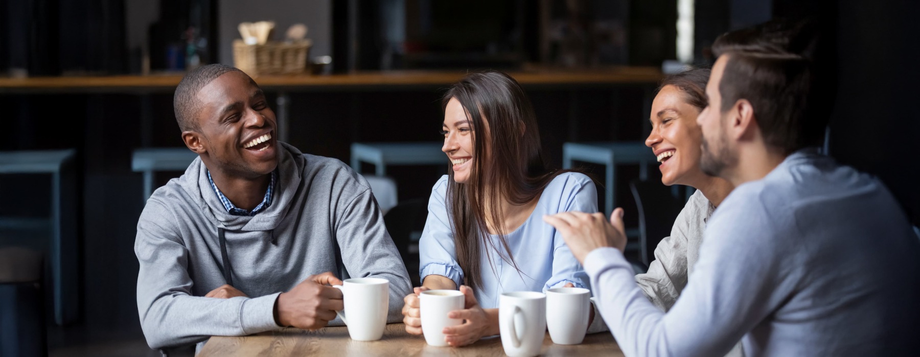 a group of people smiling with coffee