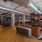a clubhouse room with seating, tables and wood floors