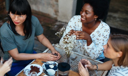 a group of women sitting at a restaurant