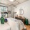 a bedroom with a bed and a mirror