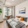 a bedroom with a bed and a plant