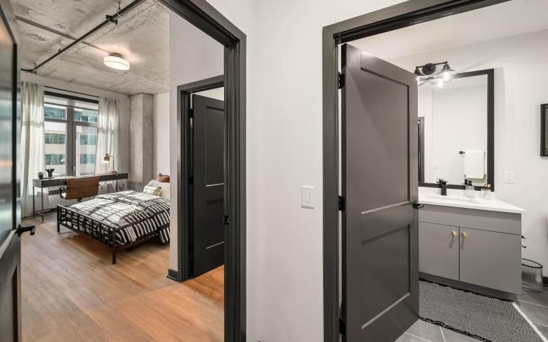 a bathroom with a bed and a sink